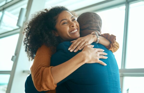 Couple hug, reunion at airport and travel with love, care and relationship, happy to see partner wi